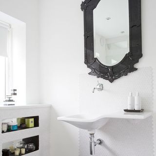 white wall with wash basin and mirror on wall