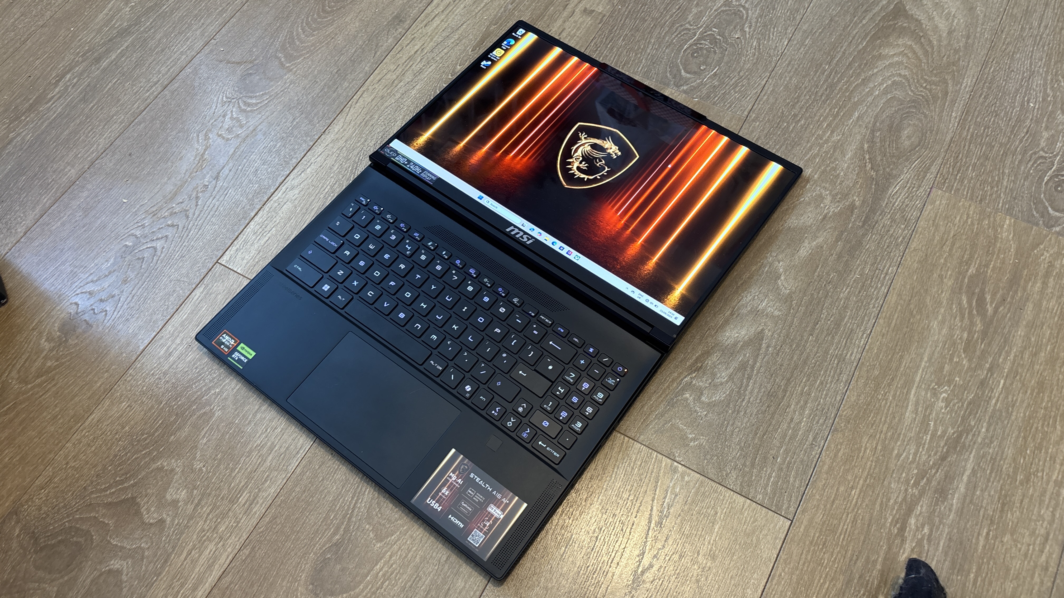 MSI Stealth A16 AI+ on wooden surface