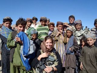 Rachel Washburn surrounded by children while on patrol in Afghanistan.
