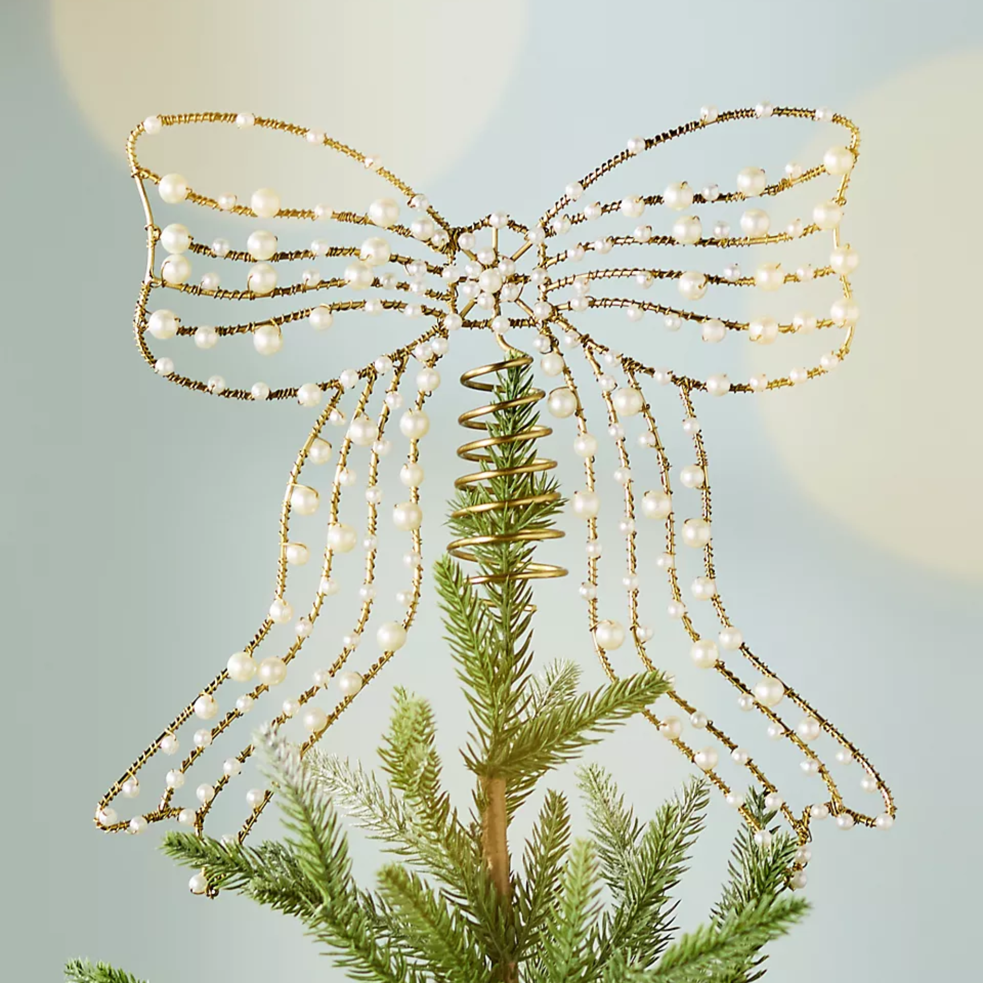 a pearl embellished bow tree topper