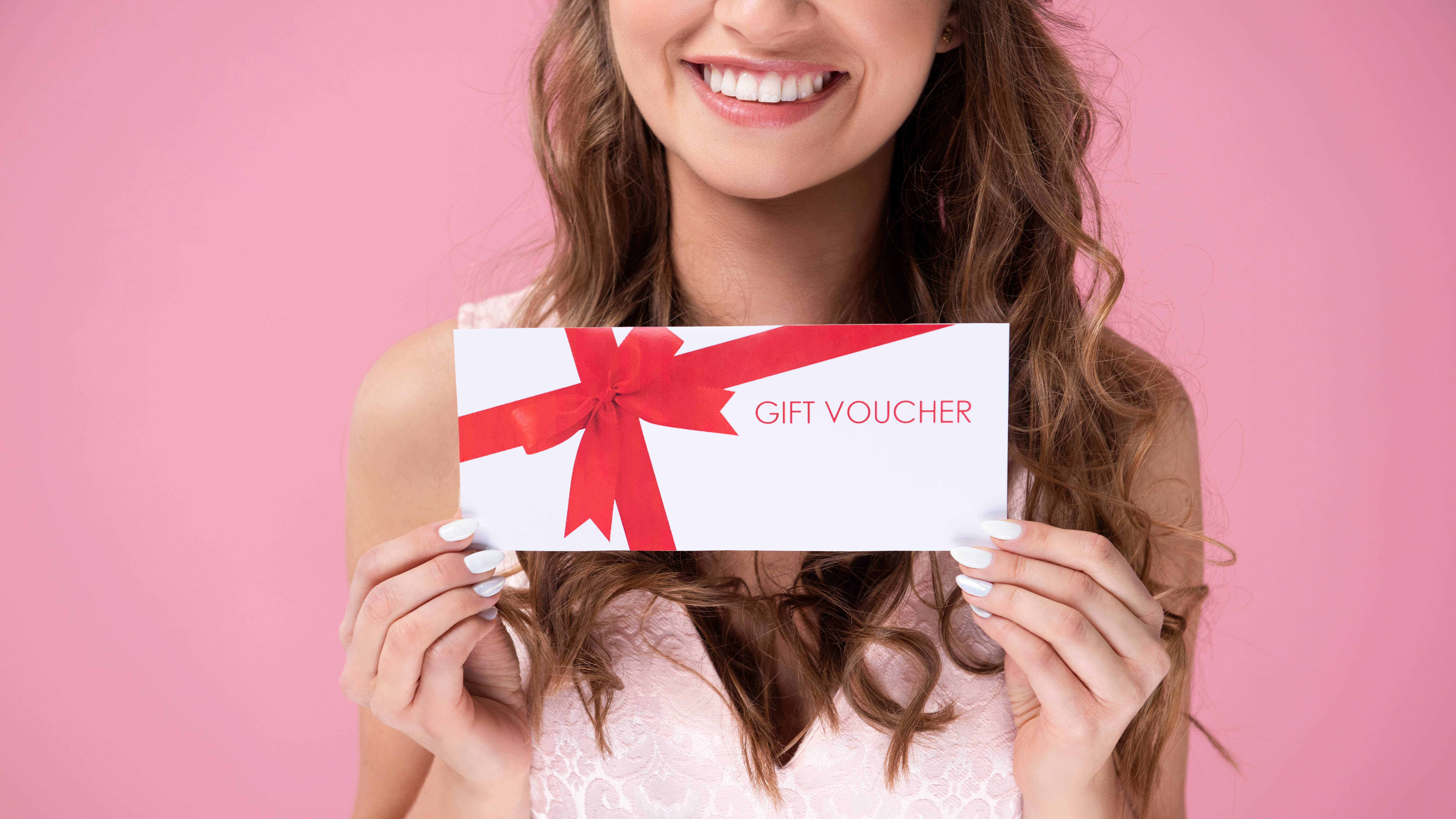 A woman holding a gift voucher