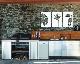 Outdoor kitchen with Scandi-tropical wall art triptych.