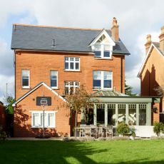 Back exterior of a Victorian house with an orangery extension