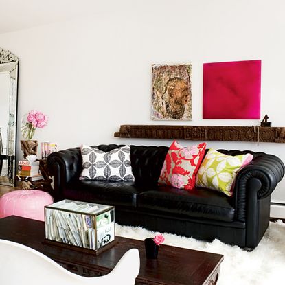 living room with white walls and sofa with cushion