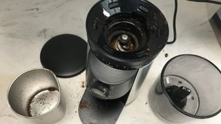 OXO grinder disassembled on the marble countertop