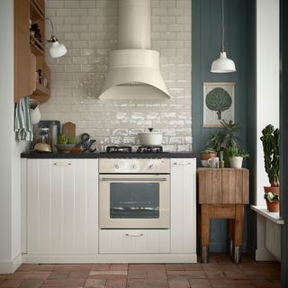 kitchen with white tiles kitchen chimney and potted plants