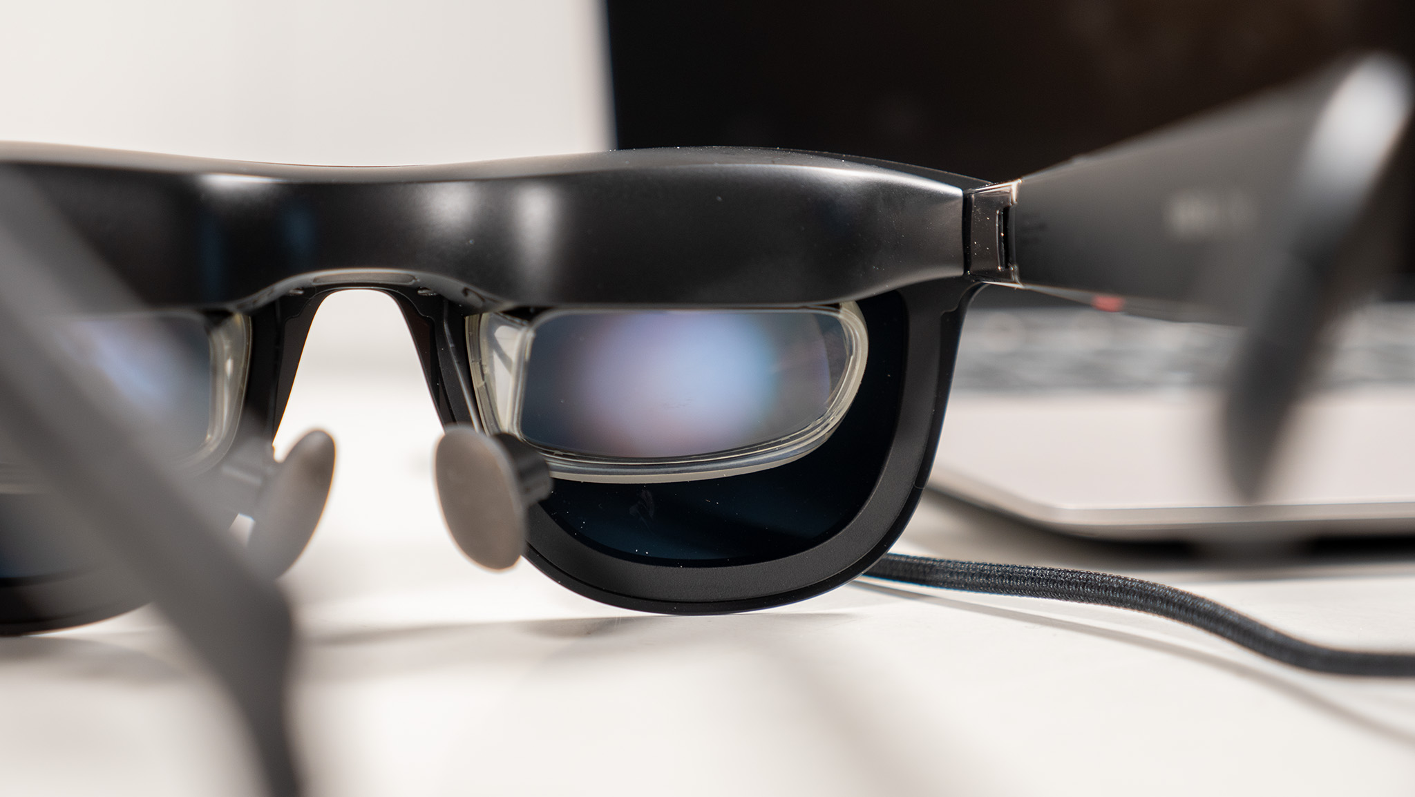 A close-up look at Xreal One smart glasses lenses while they're projecting a laptop display