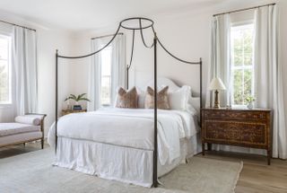 A canopy style bed in metal frame