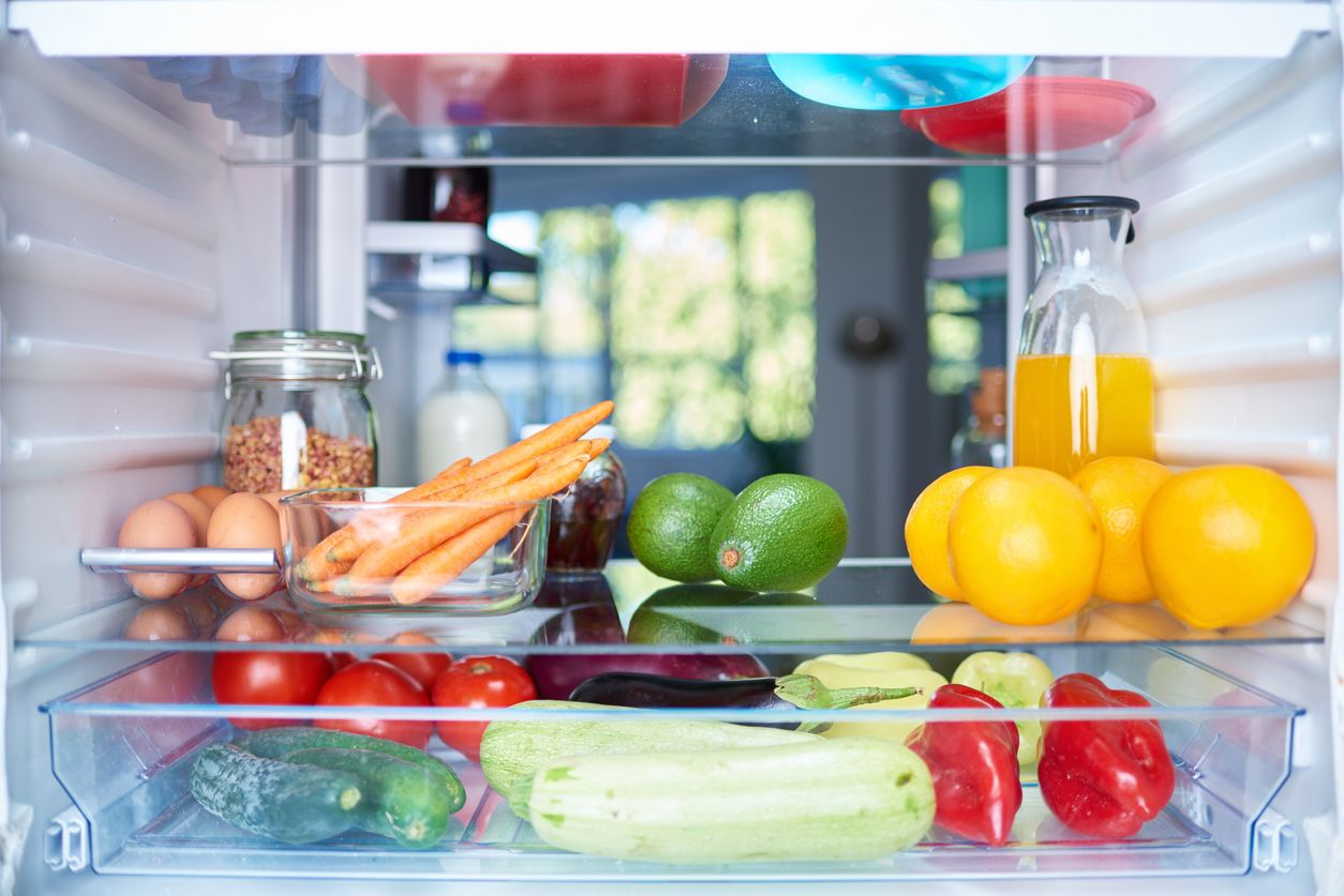 A refrigerator shelf filled with food.