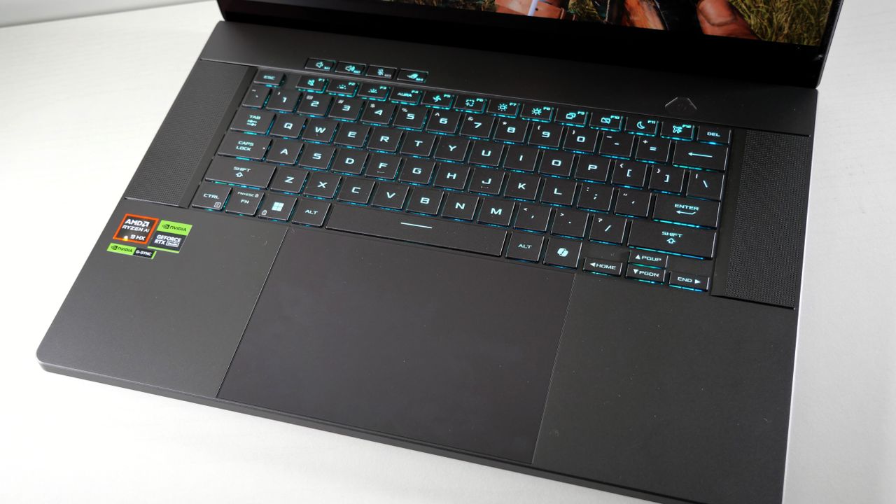 Asus ROG Zephyrus G16 (Ryzen AI 9) open with a focus on the keyboard and touchpad.