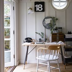 study room with white wall and wooden table with chair