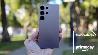 Samsung Galaxy S25 Ultra being held in the hand, with a deal badge overlayed on top