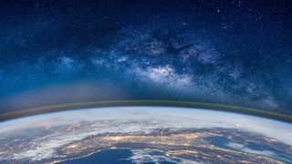 fish-eye lens photo of planet Earth from above with field of stars in the backgorund