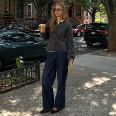 Classic Pieces 2025: @claradyrhauge wears dark indigo jeans with a grey cardigan and pointed flats