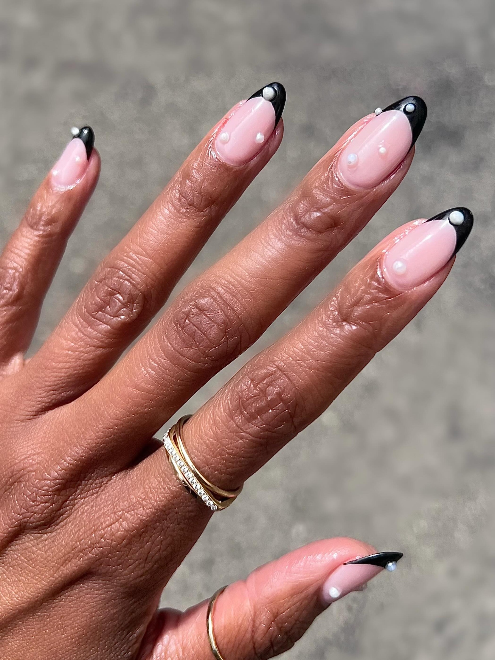 Black French tips with pearl decals.