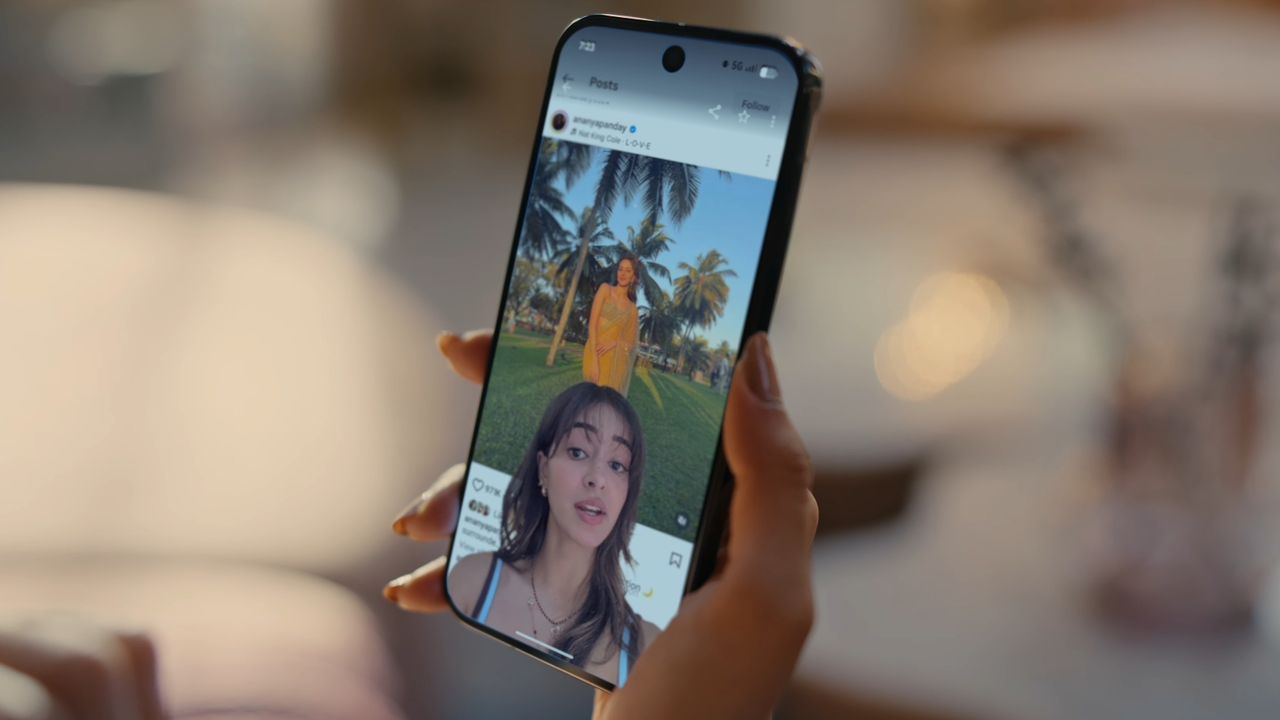 A hand holding up a Pixel phone, showing the screen reactions feature in Android 17
