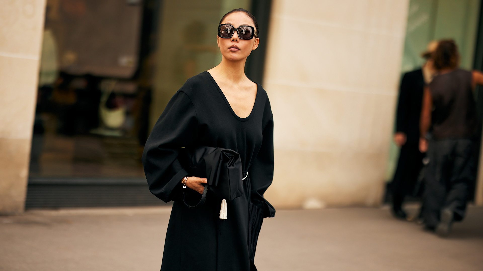 fashion week attendee wearing sunglasses, black v-neck sweater