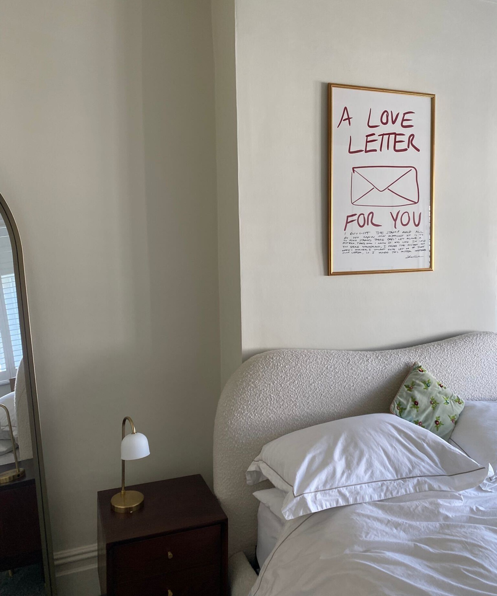 Maddie Balcombe's bedroom painted in Farrow &amp;amp; Ball's Slipper Satin with a bed with a curved headboard in cream boucle