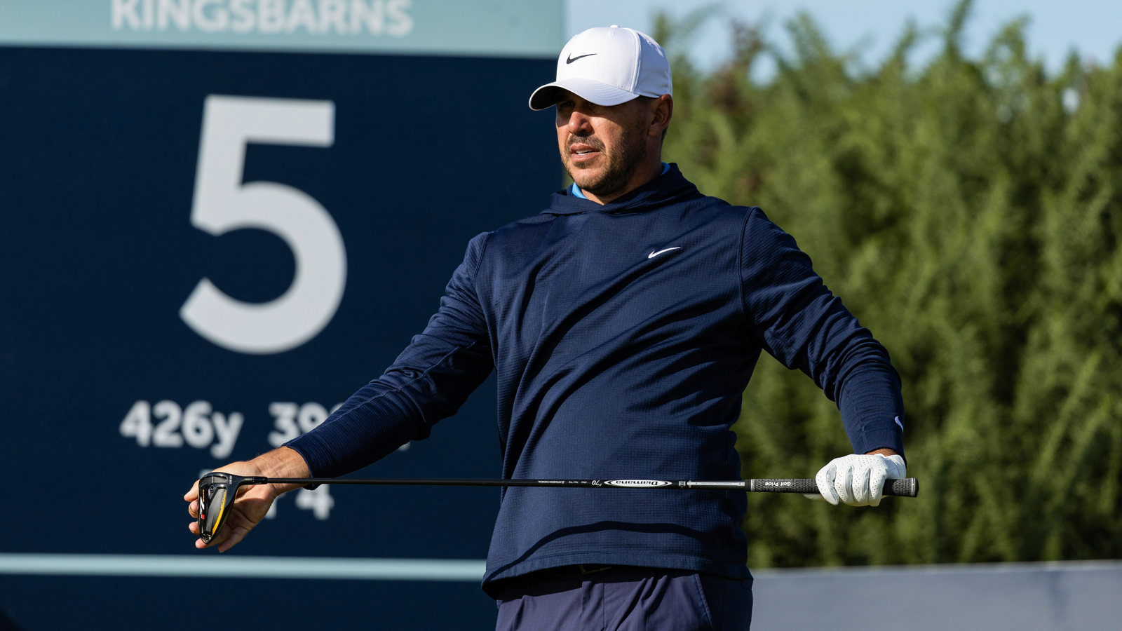 Brooks Koepka wipes the face of his mini driver