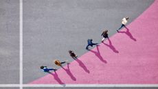 People walking along a concrete and chalk graph, symbolising growth
