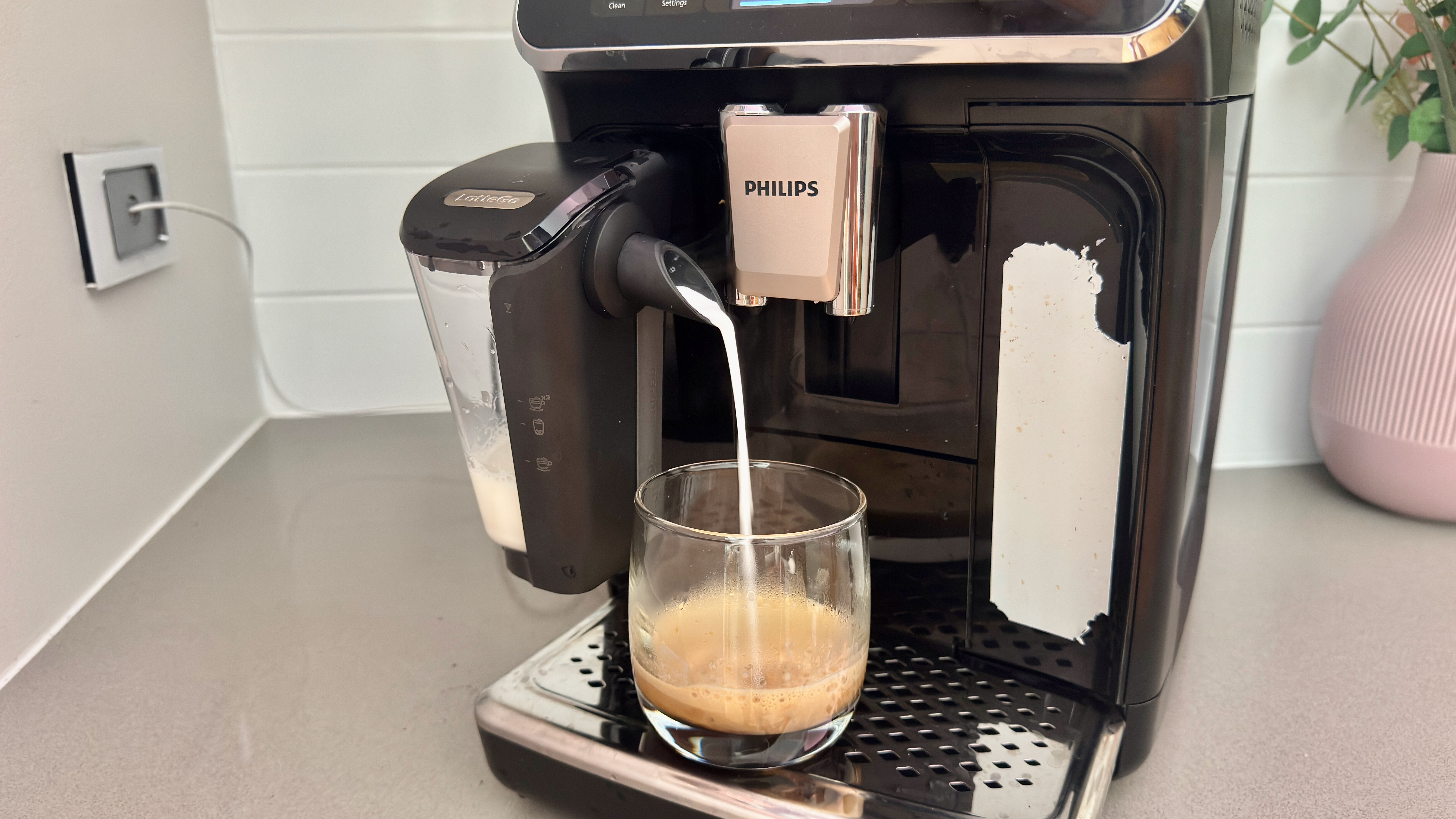 Philips 4400 Series LatteGo with milk pouring from LatteGo system