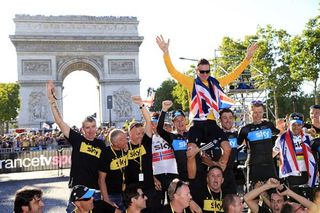 Bradley Wiggins, the first British Tour de France champion, celebrates with his Sky team.