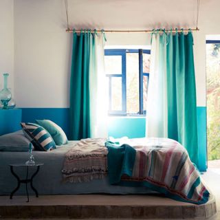 bedroom with blue windows and blue bed
