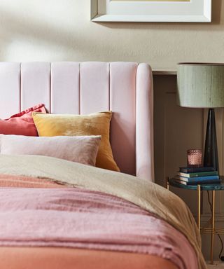 pink bed with headboard and pillows