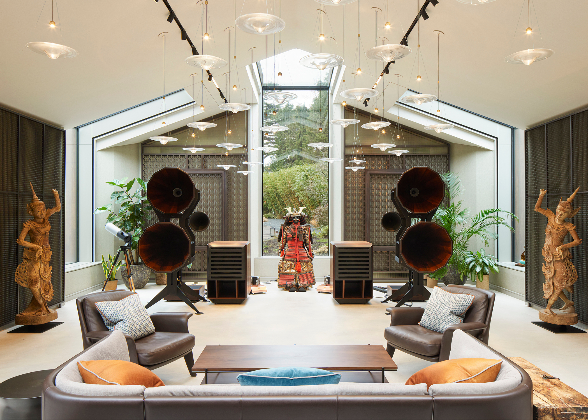 a wellness pavilion music room with Buddhist statues a seating area and large sound systems