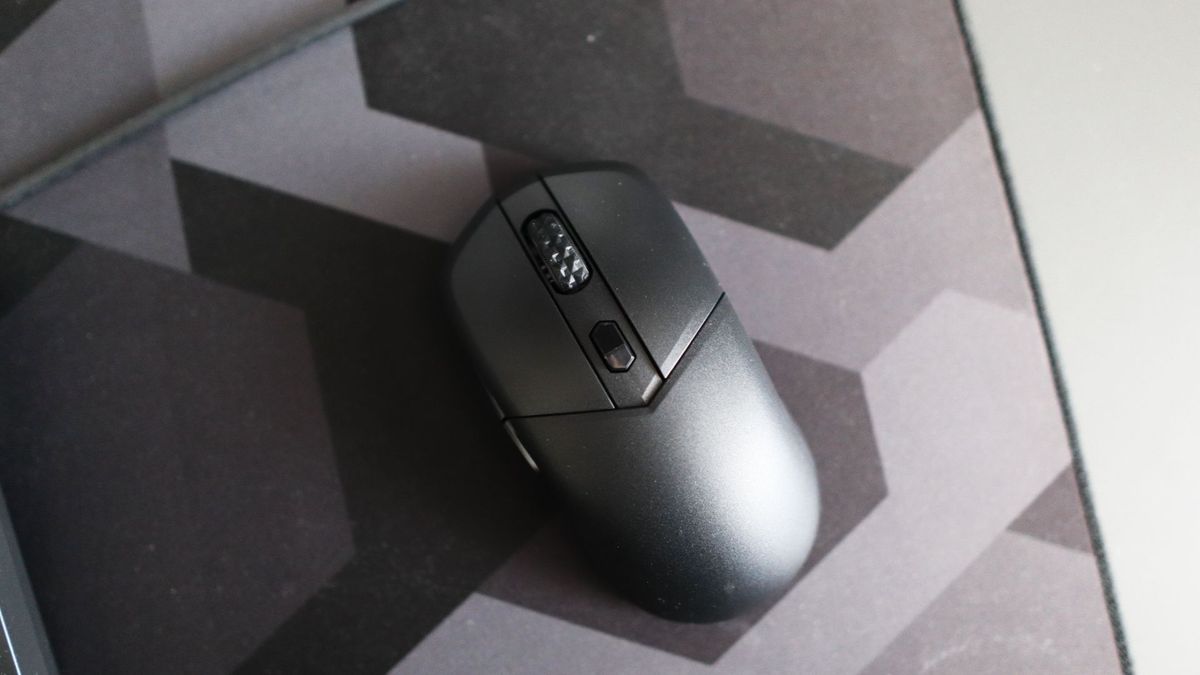 MSI Versa 300 Wireless 8K on a desk and held in a hand.