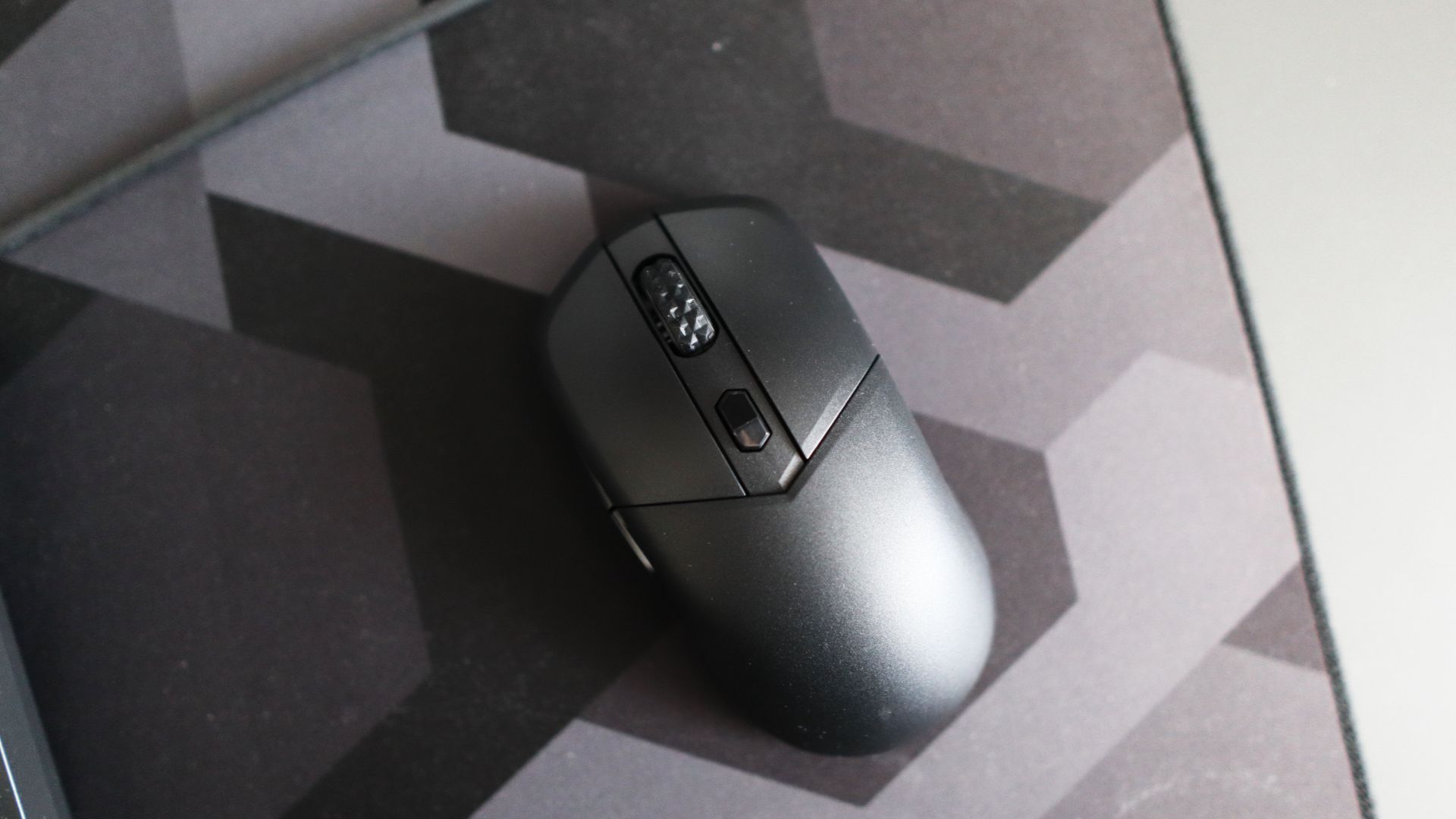 MSI Versa 300 Wireless 8K on a desk and held in a hand.