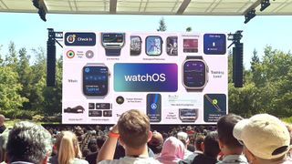A view from the crowd's perspective from WWDC 2024 showing a giant screen with all of the new Apple Watch features coming to watchOS 11 summarized.