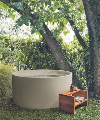 Outdoor bathroom with large concrete tub