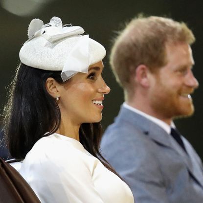 Prince Harry and Meghan Markle, seated and in profile