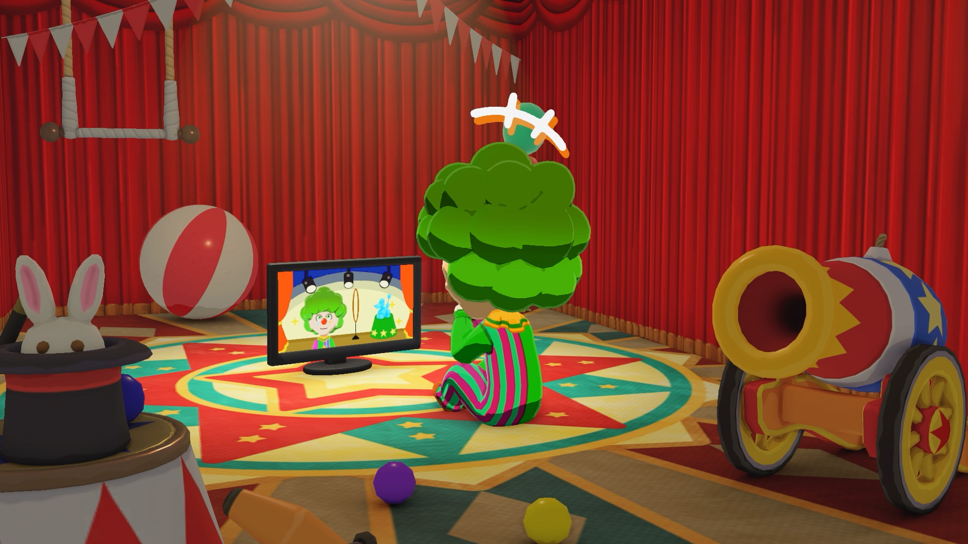Tomodachi Life: Living the Dream Mii with green hair and a clown outfit sits watching himself on a TV screen, circus supplies surrounding him