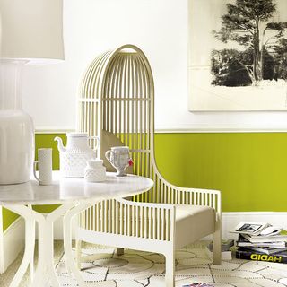 Lime green and white living room with wooden chair