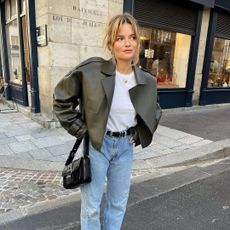 Fashion influencer @sabinasocol in Paris wearing a polished outfit with jeans.