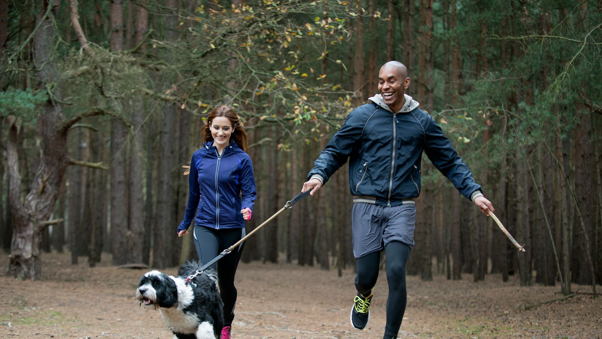 woman and man walking dog