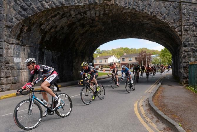 The leading group make their way under the bridge heading through the town of Killarney