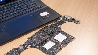 Asus Zenbook Pro 16X OLED with motherboard on table