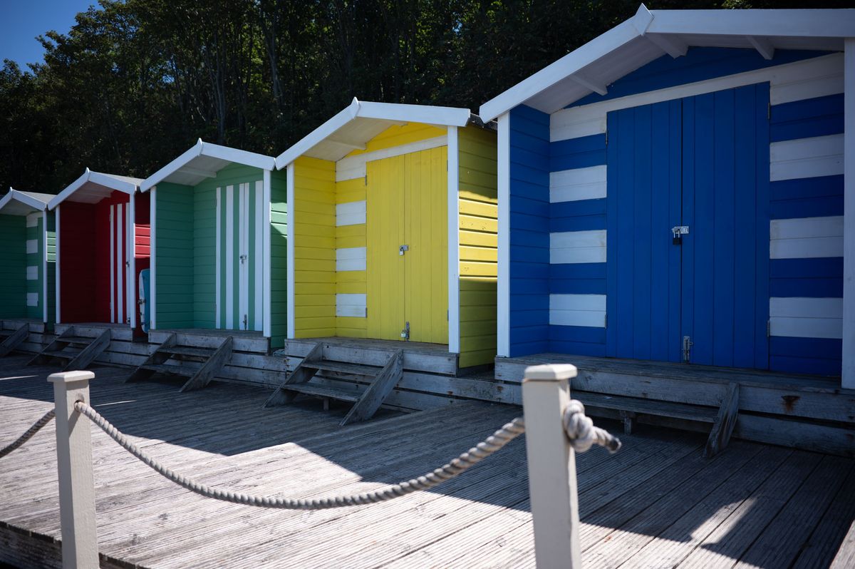 Colourful beeach huts on a sunny day