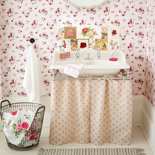 bathroom with rose wallpaper and wash basin