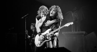 Ozzy Osbourne embraces Jake E. Lee as the latter takes a solo during an '80s live performances.