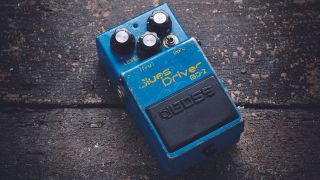 A Boss BD-2 Blues Driver overdrive pedal on a wooden floor