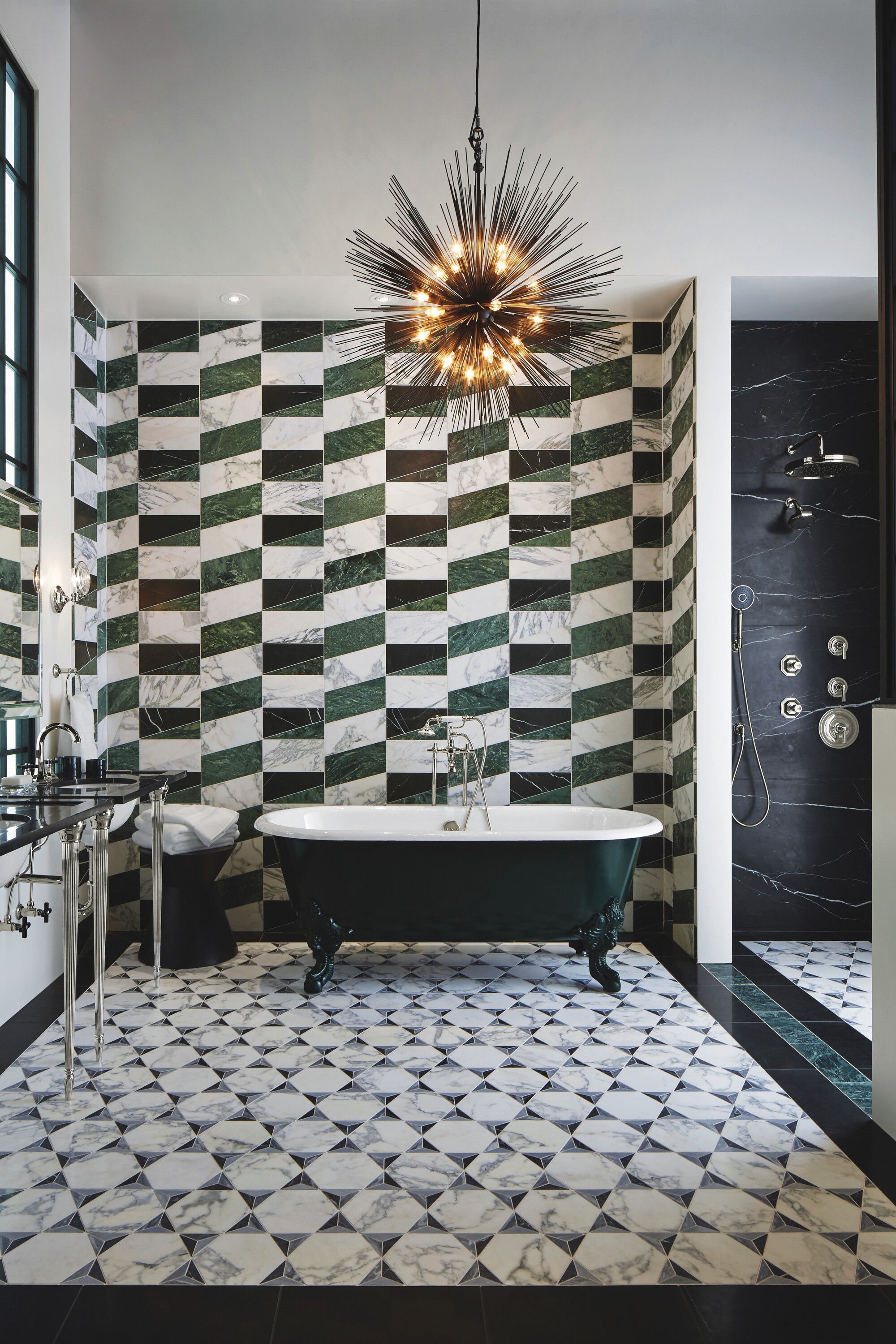 modern bathroom with green marble tiles in modern checkerboard pattern, with freestanding green tub, shower enclosure, statement pendant light