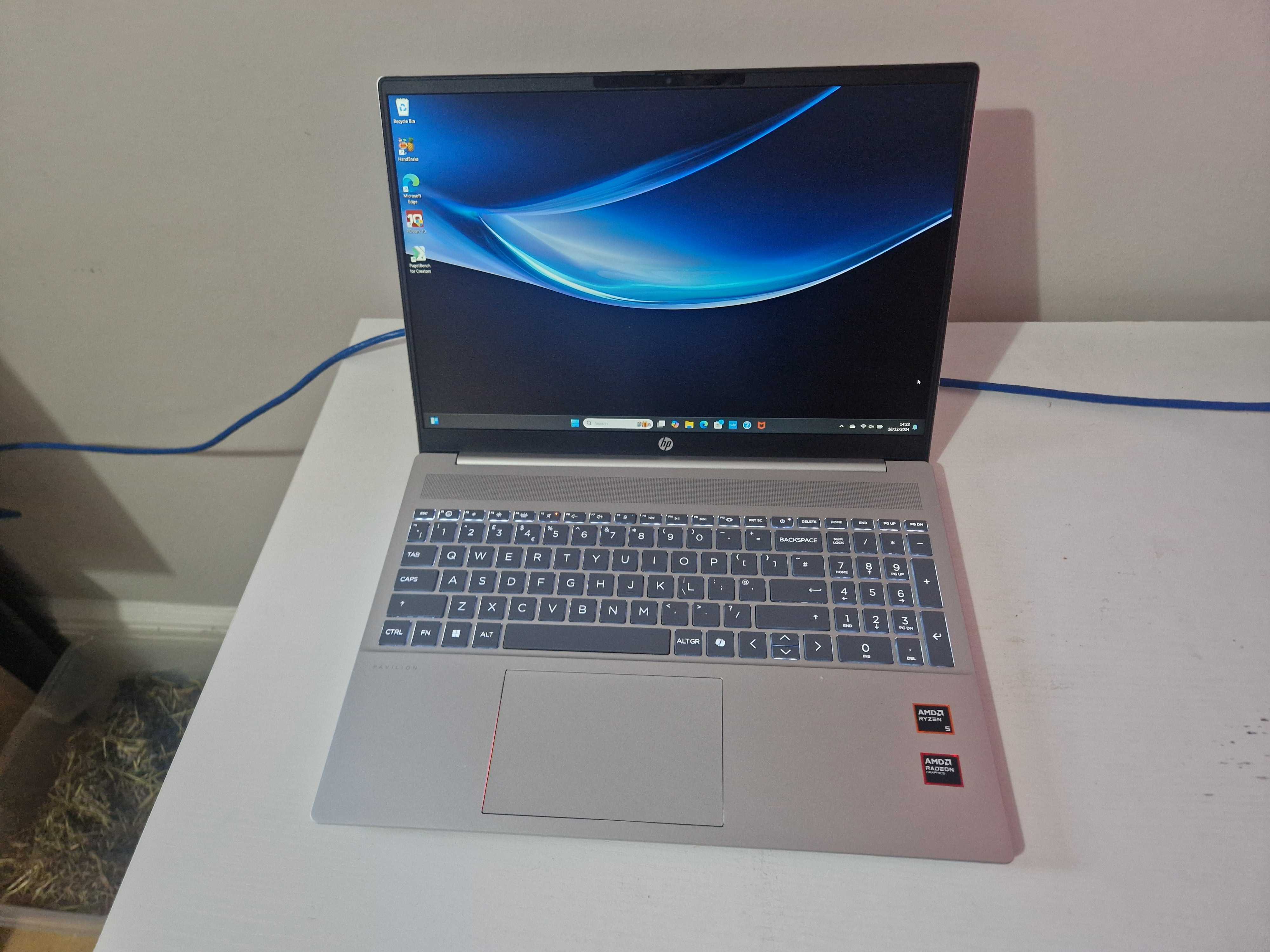 A silver HP Pavilion 16 sitting on a white desk