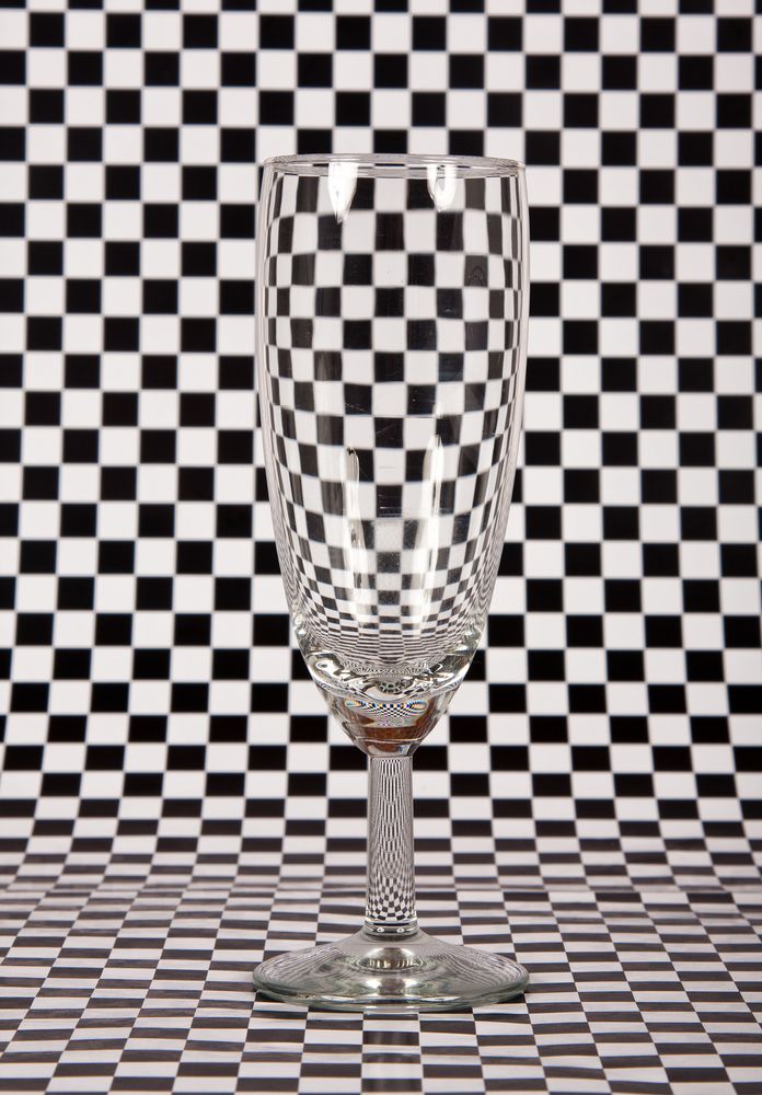 a checkerboard background with a wineglass.