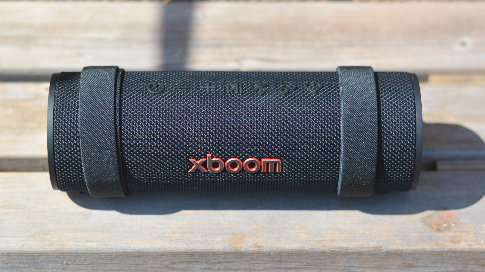 LG xboom Grab Bluetooth speaker in an outdoor setting