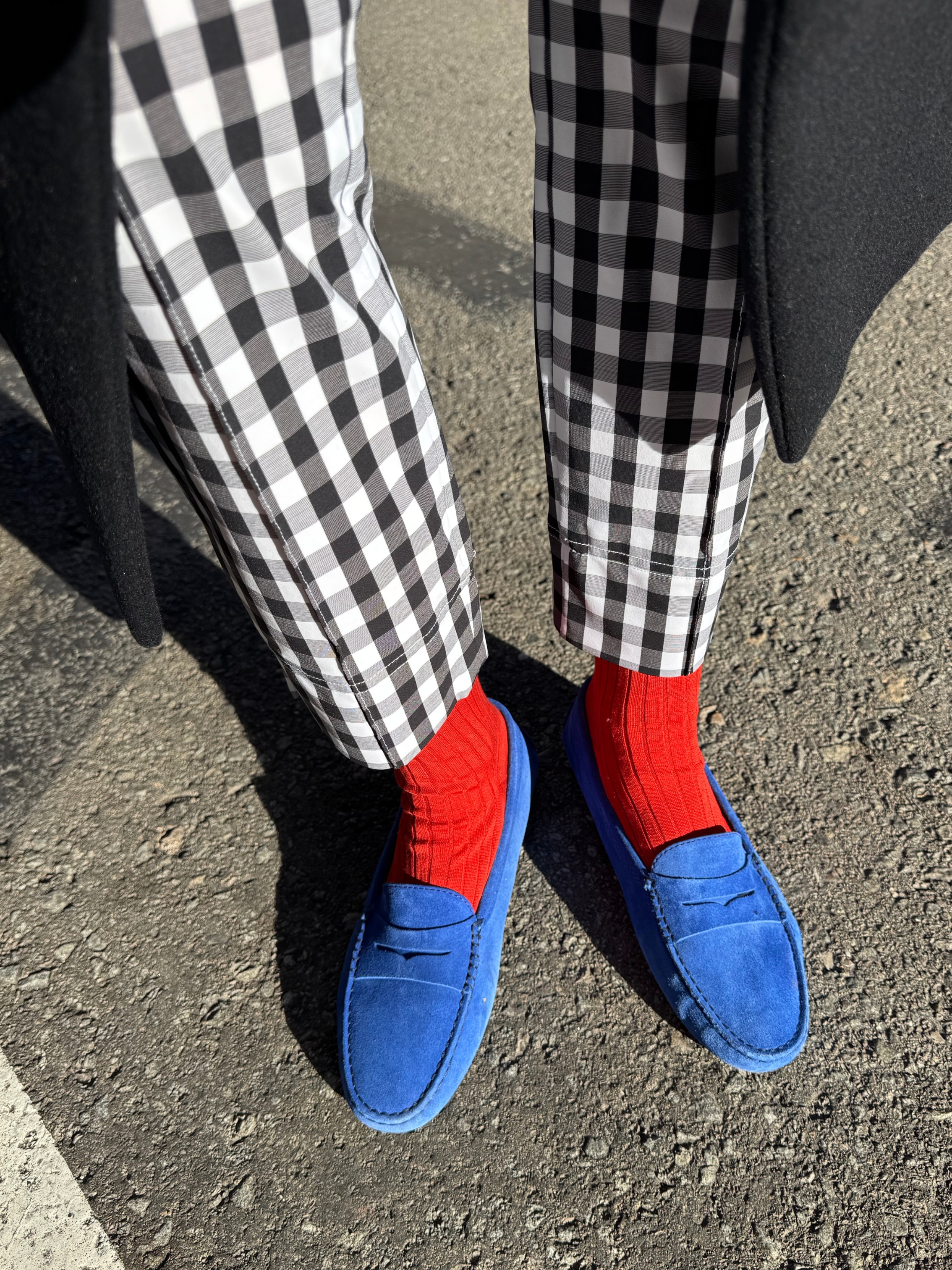 blanca miro wears gingham trousers, red socks and blue loafers