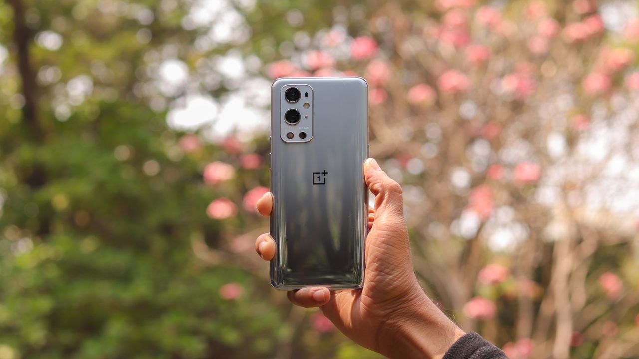 A OnePlus 9 Pro from the back, in someone's hand